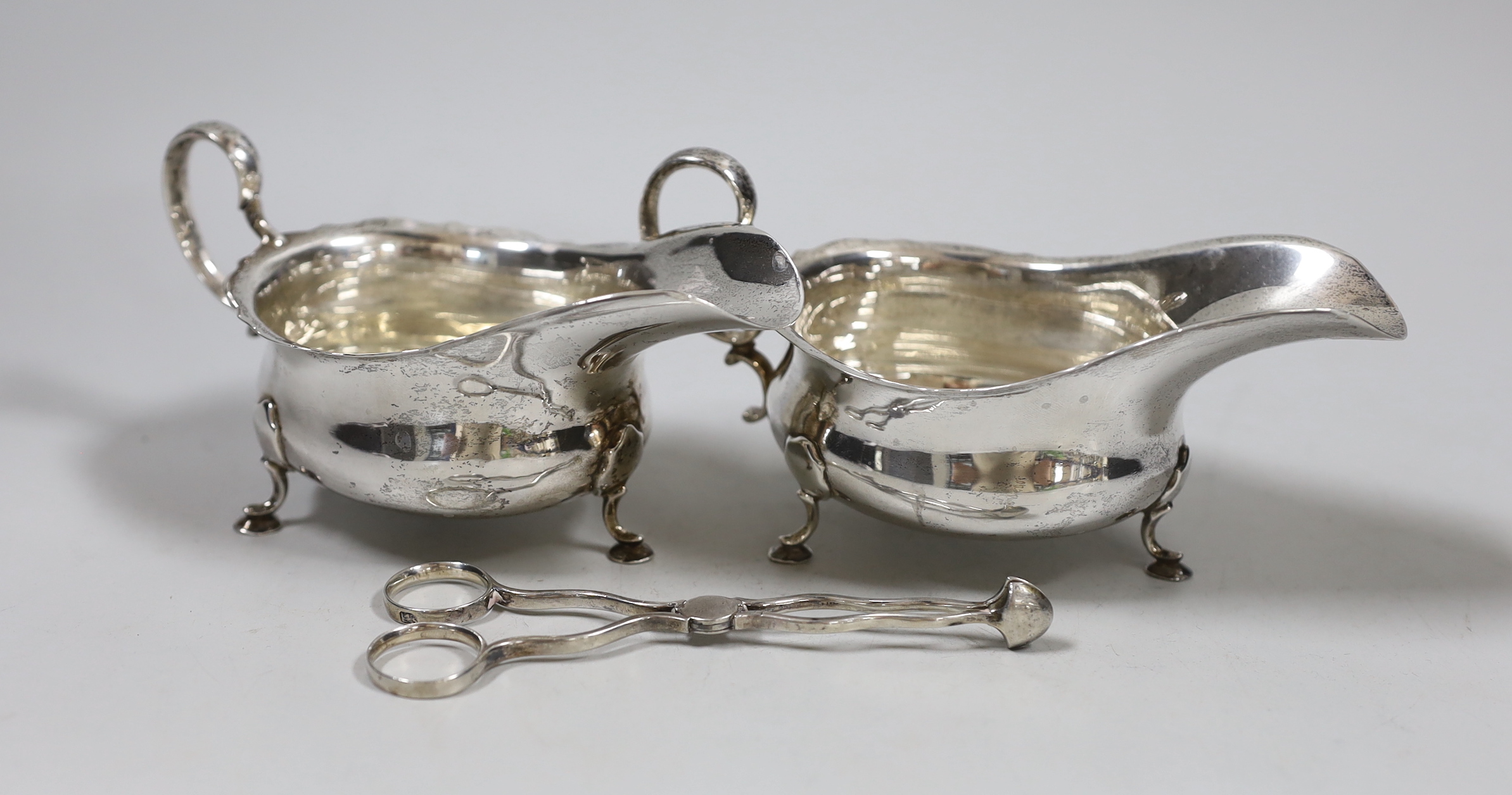 A pair of Edwardian silver sauceboats, Martin, Hall & Co, Sheffield, 1908 and a pair of 19th century silver sugar nips.